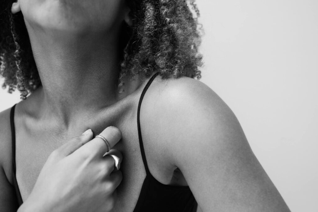 Woman standing alone with face half covered for extreme introvert article.