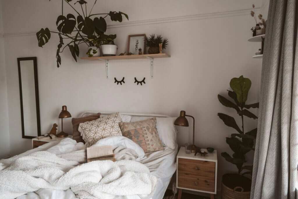 Cozy bedroom with plants and natural colors for introverted home design.